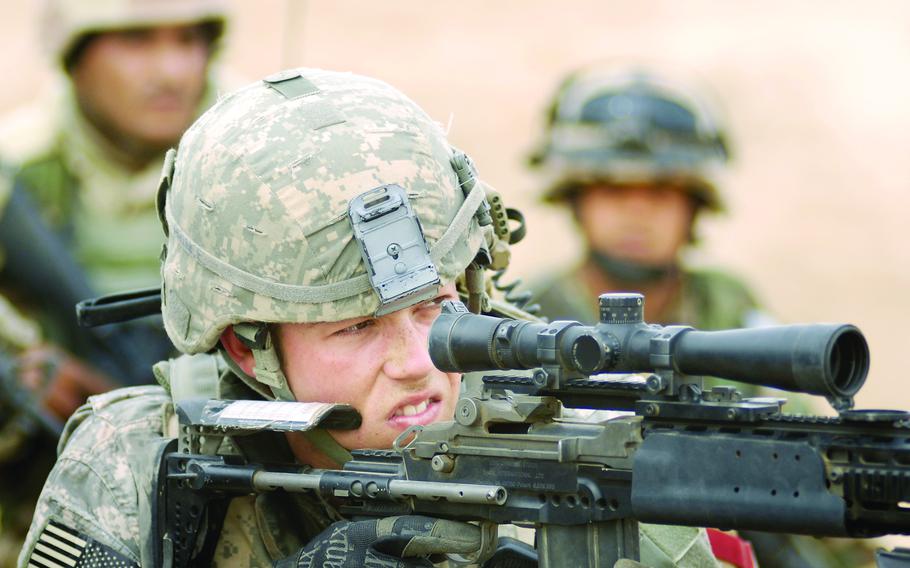 Sgt. Joseph Prince, a soldier from 3rd Platoon, Company A, Task Force 3-66 Armor, uses his scope to identify a potential target spotted by the Iraqi army while on patrol Feb. 19 in Tahweela, Iraq. 