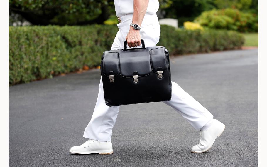 A briefcase carried by a person in a white Navy uniform is seen in Washington, D.C., on July 24, 2018. 