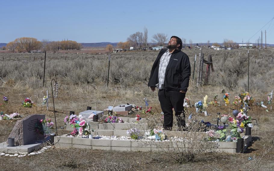 Shoshone-Paiute tribal member Michael Hanchor visits his mother’s grave, March 15, 2024, in Owyhee, Nev., on the Duck Valley Indian Reservation that straddles the Nevada-Idaho border.