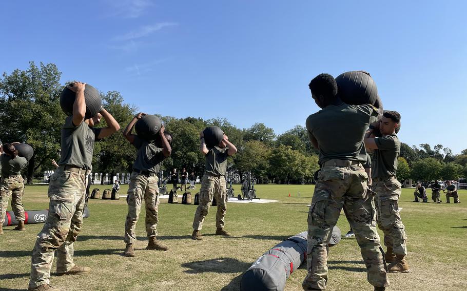 All five soldiers in one of the competing squads hold weighted balls in sync during the Army Best Squad Fitness Event in Washington, D.C., Oct. 12, 2024. 