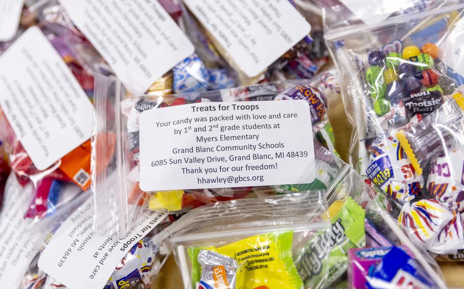 First and second grade students help fill bags of donated Halloween candy 