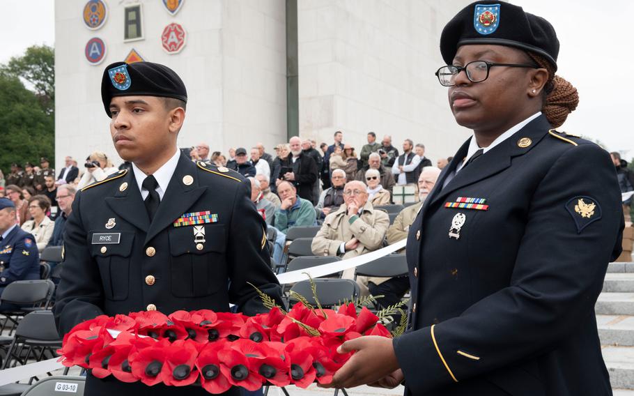Cpl. Isaiah Ryce, left, and Spc. Tamara Laurent, who support U.S. Army Garrison Benelux, lay wreaths during a Memorial Day ceremony at Ardennes American Cemetery in Neupré, Belgium, on May 25, 2024. 