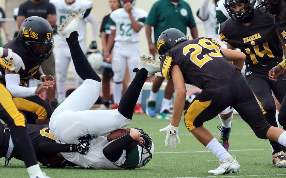 Kadena defenders Isiah Cepin and Samuel Valdez home in on Kubasaki back Lukas Gaines.