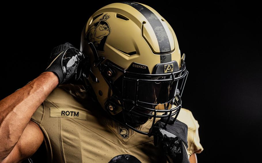 An Army player puts his hand behind his helmet.