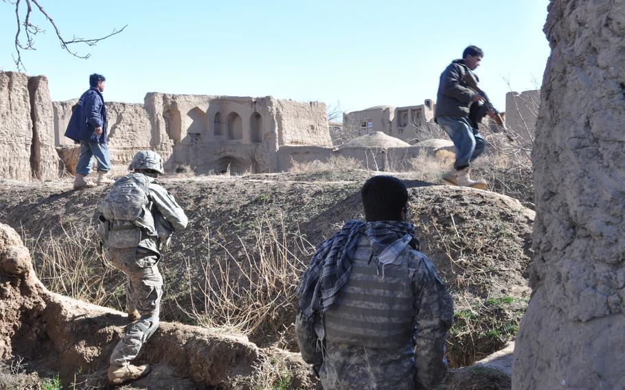 U.S. soldiers with the 4th Squadron, 73rd Cavalry Regiment of the 82nd Airborne follow their Afghan National Police colleagues into the village of Dashta Bam in the Pashtun Zarghun district of Herat province on Feb. 9 in search of a bomb triggerman. A small homemade bomb only partially exploded just after their vehicle passed earlier in the day, causing no damage. 