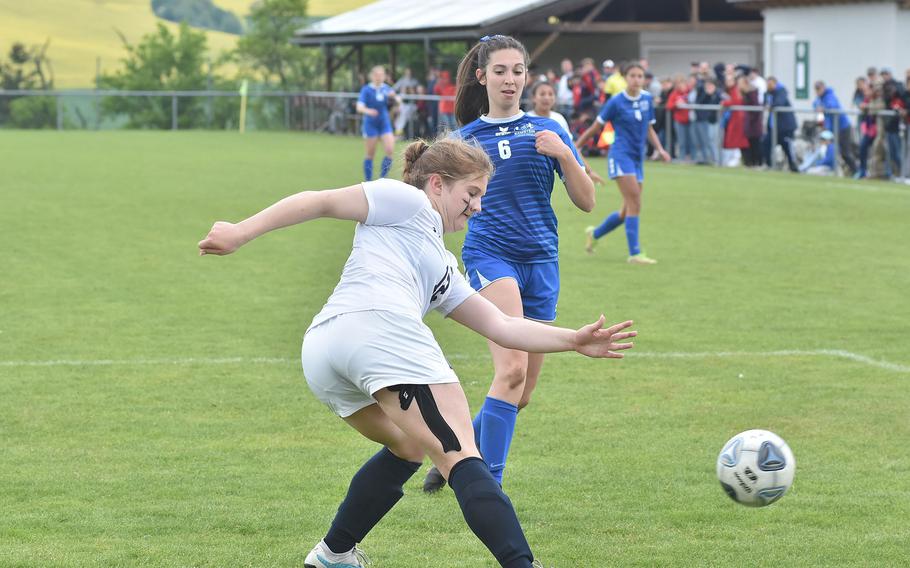 Lakenheath's Sophia Yorko kicks the ball away before Ramstein's Eleftheria Randitsas can get to her in the Warriors' 1-0 victory over the Royals in the DODEA-Europe Division I girls semifinals Wednesday, May 17, 2023, in Reichenbach-Steegen, Germany.