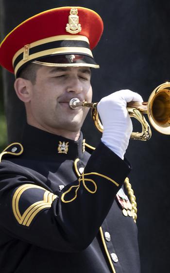Sgt. 1st Class Kevin Paul of the U.S. Army Band plays Taps during the 20th anniversary celebration of the National World War II Memorial in Washington, May 25, 2024.