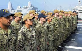 Sailors aboard the littoral combat ship USS Oakland stand in formation on the flight deck during a change of command ceremony in October 2024. The Navy issued new guidance Feb. 25, 2025, to comply with a federal mandate recognizing only two biological sexes, male and female, and ending gender identity efforts.