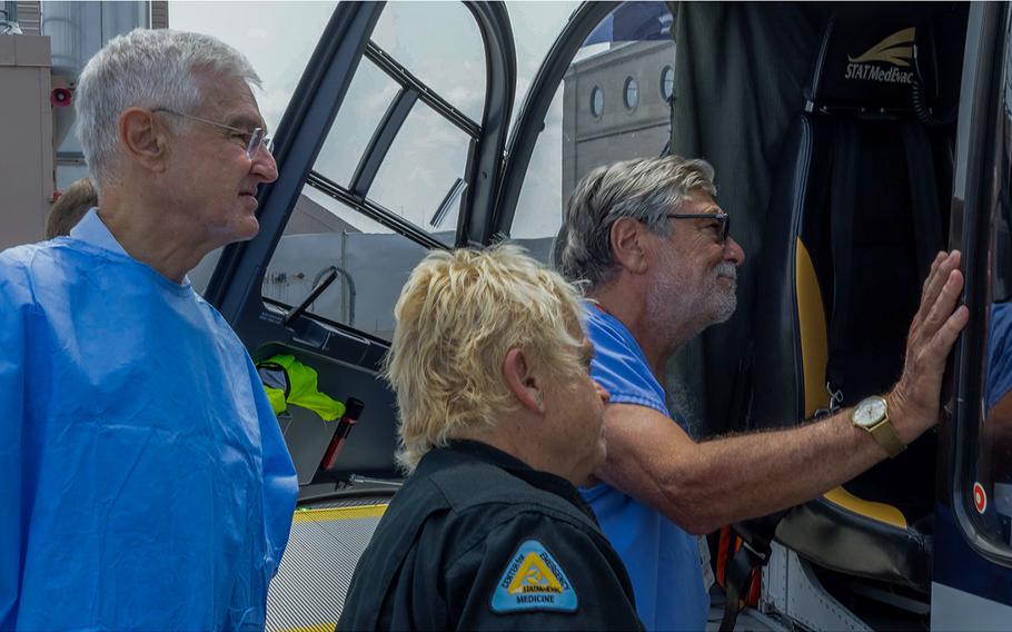 Ronald Poropatich, M.D., left, director of the University of Pittsburgh Center for Military Medicine, and Michael R. Pinsky, M.D., right, professor in the University of Pittsburgh School of Medicine, bid farewell to a Stat MedEvac flight crew before they test the ReFit system’s capabilities in a medical helicopter transport. 