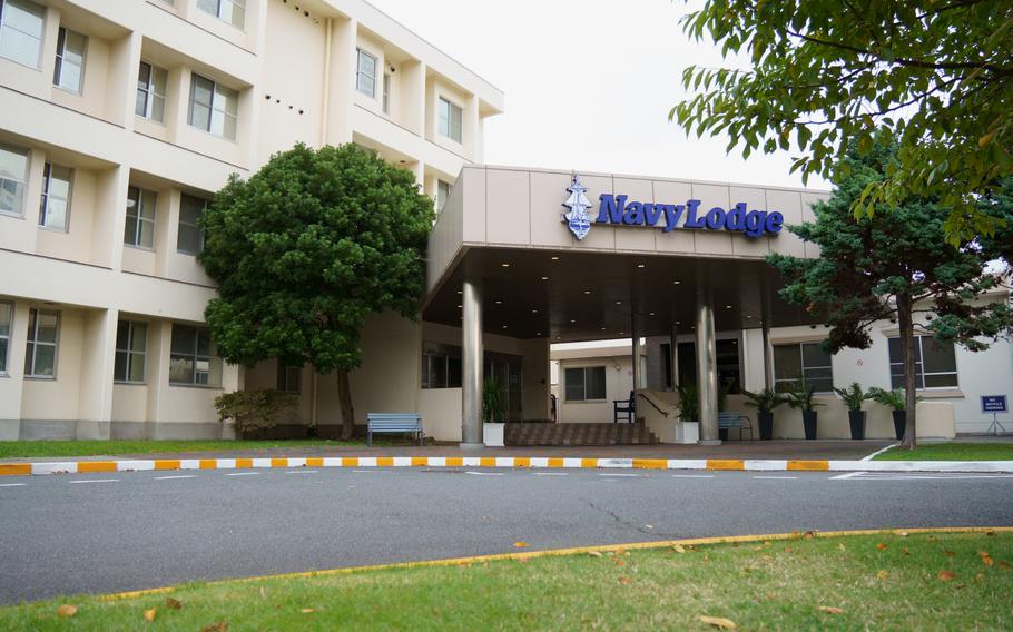 The beige exterior of the Navy Lodge at Yokosuka Naval base in Japan has blue lettering that reads Navy Lodge.