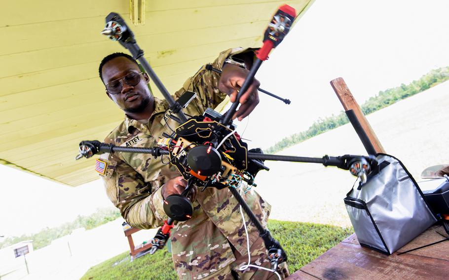 Army Spc. Oria Attey prepares his drone for a test flight in Georgia at a Hinesville airfield on July 26, 2024. Attey of the 3rd Infantry Division participated in a first-of-its-kind drone building class run by the division’s Marne Innovation Center at Fort Stewart. 