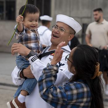 Logistics Specialist 2nd Class Edgardo Manzaniloa greets his family after the USS Leyte Gulf returned to Naval Station Norfolk on May 17, 2024, following its final deployment.