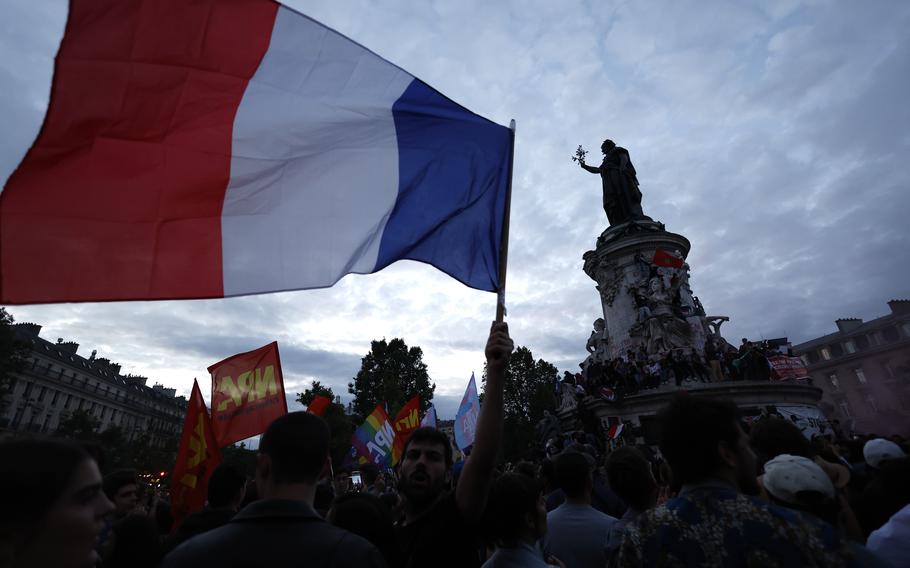 People gather on the Republique plaza following the second round of the legislative elections, Sunday, July 7, 2024 in Paris. 