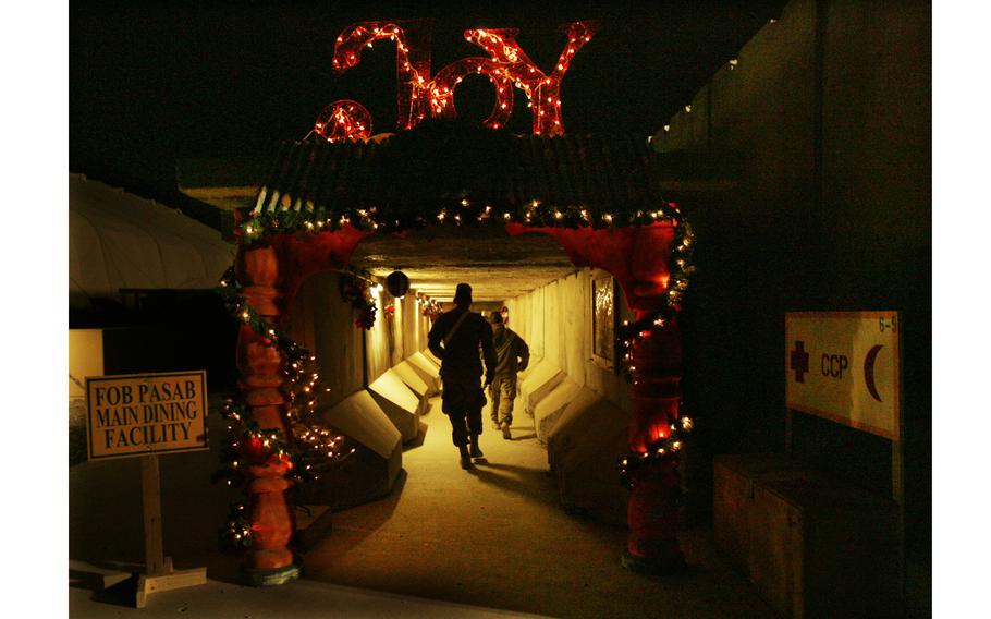 Soldiers make their way through holiday decorations