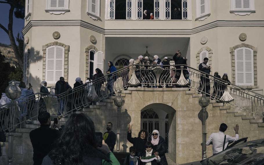 Civilians gather at Asma al-Assad’s palace in Damascus, Syria, on Monday after it was looted. 