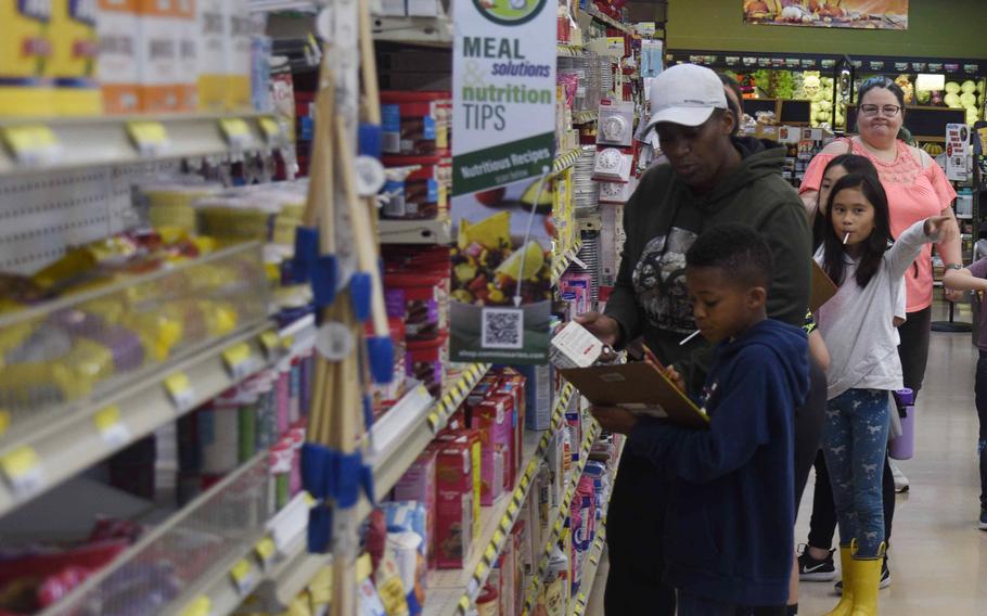 Elementary students shop at the commissary in Japan.