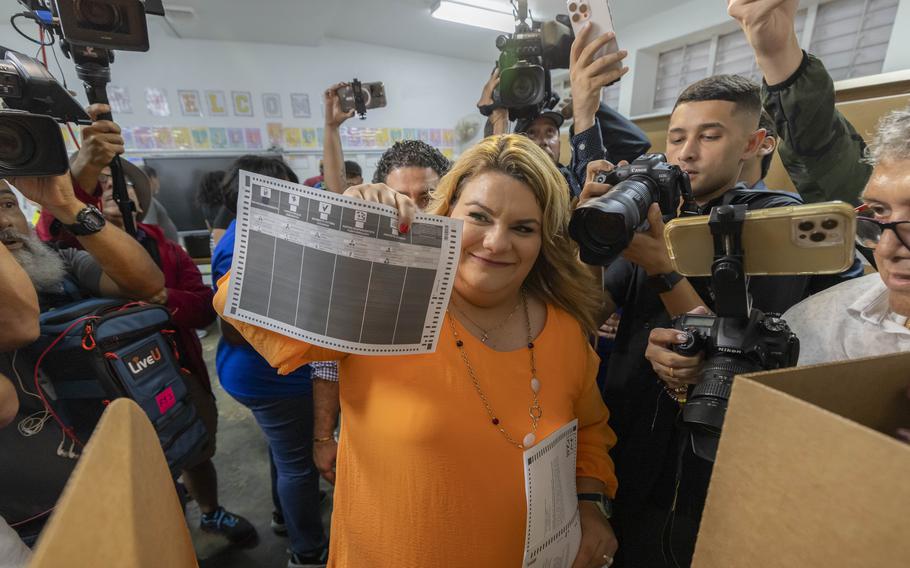 Jenniffer González, a Puerto Rico gubernatorial candidate representing the New Progressive Party, shows her ballot to the cameras.