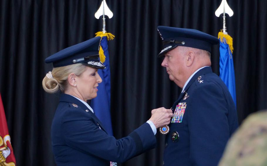 Lt. Gen. Laura Lenderman presents a medal to Lt. Gen. Ricky Rupp.