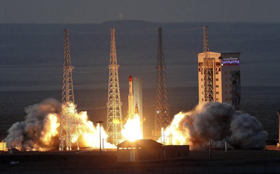 Flames and exhaust from a rocket launch in Iran.