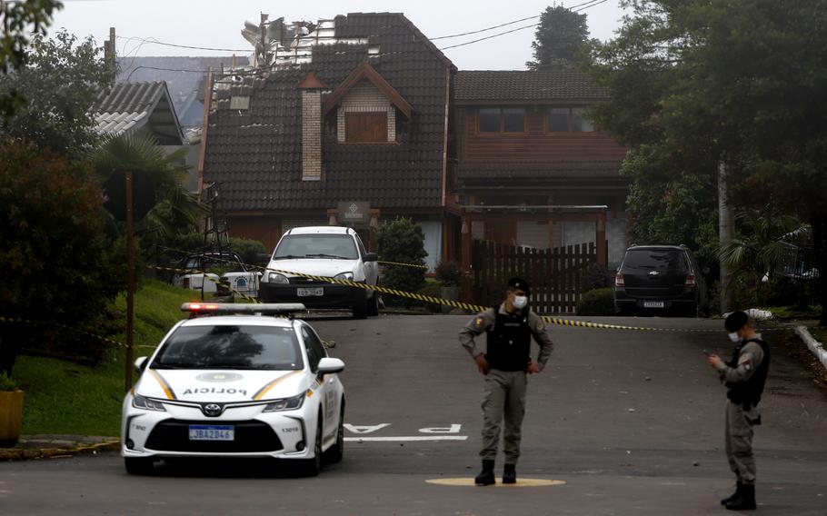 Police cordon off houses following a plane crash.