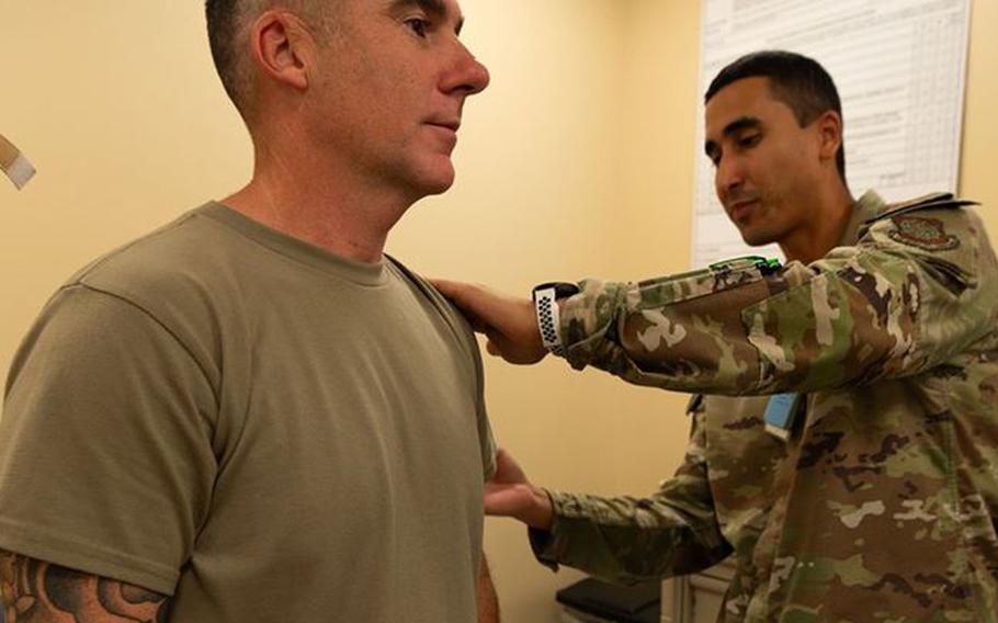 Chief Master Sgt. Raun Howell receives a flu shot from Tech. Sgt. Orlando Navarro.