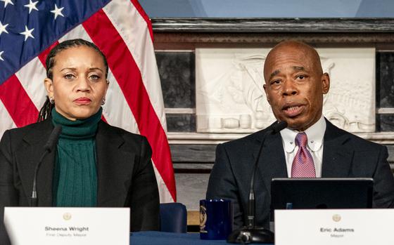 FILE - Mayor Eric Adams, right, is flanked by deputy mayor Sheena Wright, left, during a press conference at City Hall in New York, Dec. 12, 2023. (AP Photo/Peter K. Afriyie, File)