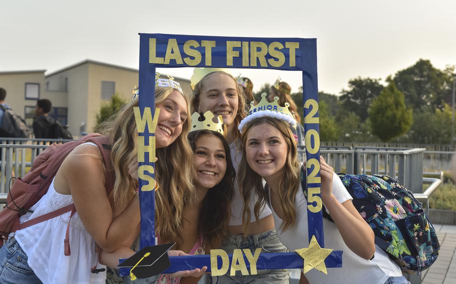 Senior Roni Massey, second from the left, poses with fellow seniors before the first day of the 2024-2025 school year on Aug. 19, 2024. outside of Wiesbaden High School, Germany. Warrior seniors wore crowns to celebrate their last, first day of school as kings and queens of the hallways.