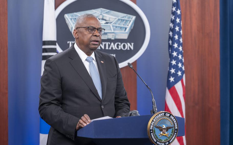 Defense Secretary Lloyd Austin stands at a podium at the Pentagon.