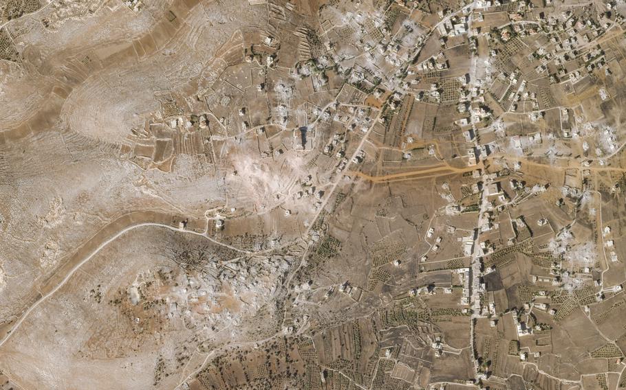 A satellite image of the Lebanese village of Mhaibib, with a gray mass indicating destroyed buildings.