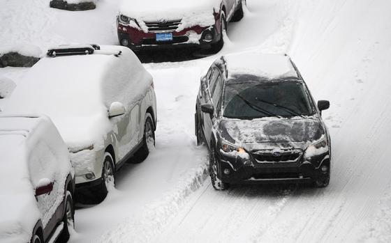 A motorist struggles to move along Pearl Street as a winter storm sweeps over the intermountain West, plunging temperatures into the single digits and bringing along a light snow in its wake Saturday, Jan. 18, 2025, in Denver. (AP Photo/David Zalubowski)