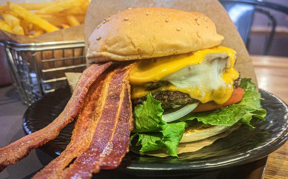 Mars Burger Co.'s I Dream of Bacon Burger is a satisfying mix of juicy beef patty, melted cheese and two long strips of crispy bacon stacked with fresh lettuce, tomato and onion on a toasted sesame bun. 