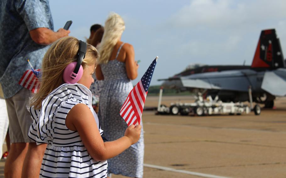 Anna Moreno, 4, plays with an American flag on Friday, July 12, 2024, while waiting for her father and F-18 pilot Cmdr. Jaime Moreno to return home.