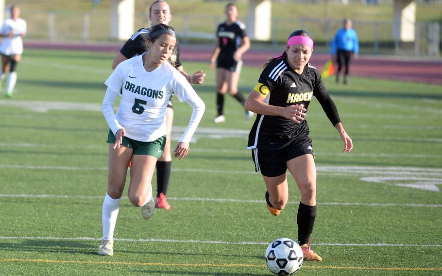 Nadine Espindola and Emmah Strong run after the ball.