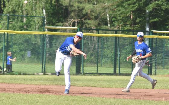 Ramstein’s Caden Nims throws to first as teammate Luke Seaburgh watches during the Royals’ 7-5 victory over Stuttgart on Friday, May 24, 2024, in the DODEA-Europe Division I championship game.