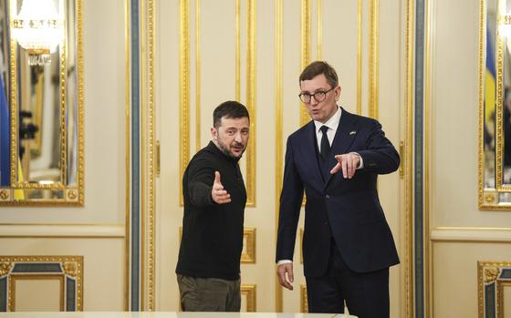 Ukraine's President Volodymyr Zelenskyy, left, and Estonia's Prime Minister Kristen Michal talk before a meeting in Kyiv, Ukraine, Dec. 9, 2024. (AP Photo/Evgeniy Maloletka)