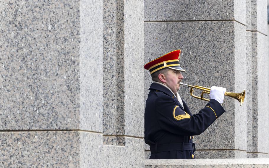 A bugler plays taps.