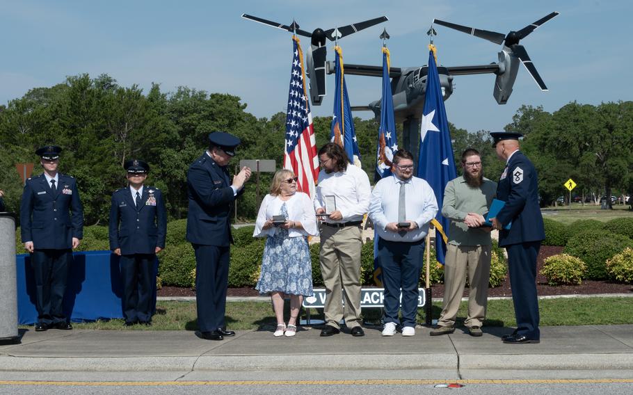 U.S. Air Force Lt. Gen. Tony Bauernfeind, commander of Air Force Special Operations Command, presents the Distinguished Flying Cross to the family of U.S. Air Force Senior Master Sgt. James Lackey, a CV-22B Osprey flight engineer, on his behalf at the Voas-Lackey Roundabout at Hurlburt Field, Florida, May 16, 2024. Lackey posthumously received the DFC for his actions taken during a combat mission near Qalat, Afghanistan, April 9, 2010.