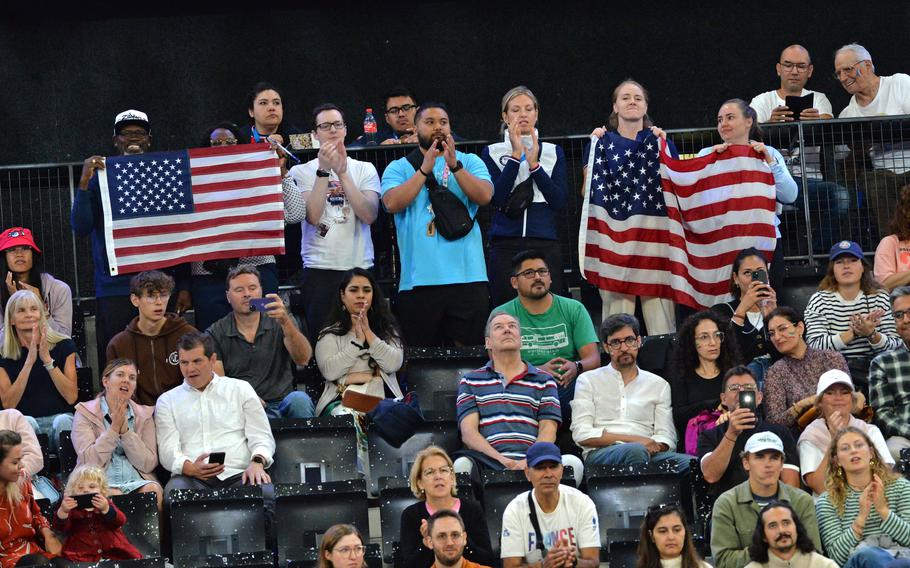 Fans cheer on American Bobby Body at the La Chapelle Arena during the para powerlifting competition at the 2024 Paris Paralympics. Body, an Army veteran, finished fourth in the up to 107-kilogram class, lifting 218 kilogram, or 480.60 pounds.