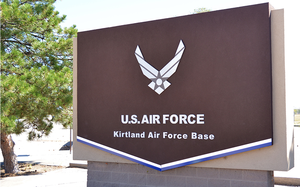 An entrance sign reading “U.S. AIR FORCE” and “Kirtland Air Force Base.”