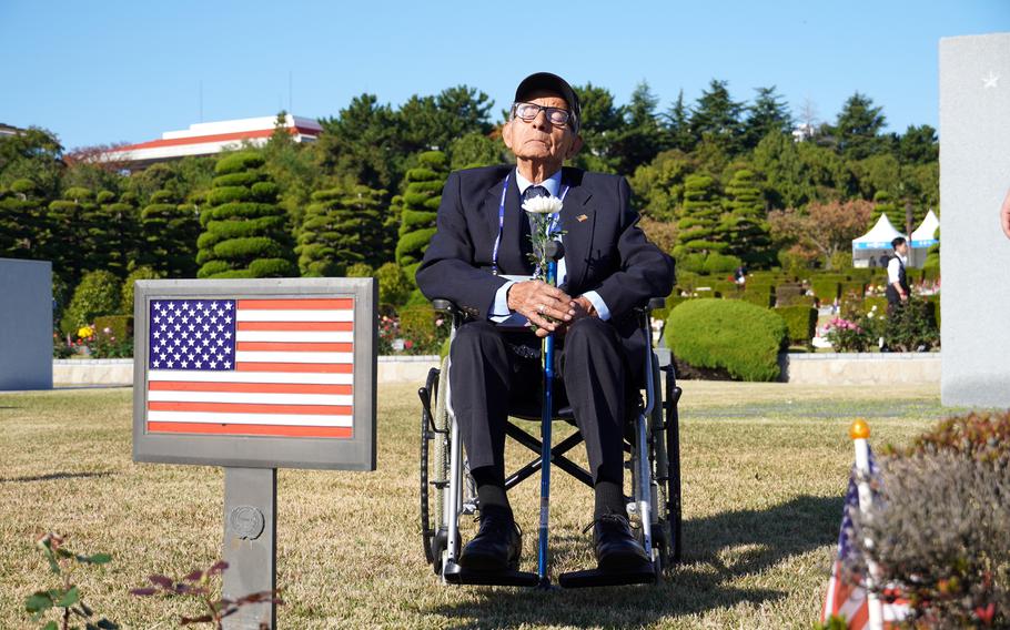 Aurelio Aguilar Ruiz, 94, visits a U.S. service member's gravesite at the U.N. cemetery in Busan, South Korea, Nov. 11, 2024. Ruiz said he served as a 1st Infantry Division rifleman during the Korean War. 