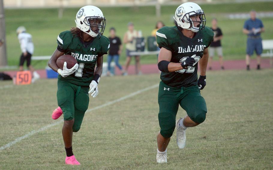 Kubasaki's Carlos Cadet gets an escort from teammate Kaito Moore for his 44-yard punt-return touchdown.