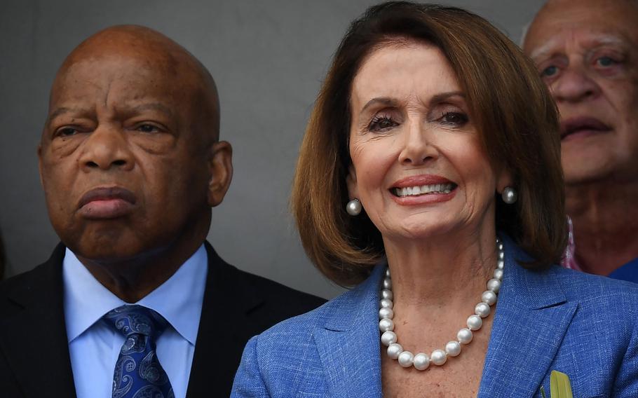 Rep. Nancy Pelosi (D-California), right, stands with civil rights icon, Rep. John Lewis (D-Georgia), left, during a rally in Los Angeles on April 9, 2017. 