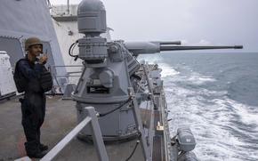 240815-N-WV584-1019 SINGAPORE STRAIT (Aug. 15, 2024) Gunner’s Mate 2nd Class John Lopez, from Hemet, Calif., stands watch on the Mk 38 25mm machine gun system aboard the Arleigh Burke-class guided-missile destroyer USS Spruance (DDG 111). Spruance, assigned to the Abraham Lincoln Carrier Strike Group, is underway conducting routine operations in the U.S. 7th Fleet area of operations. U.S. 7th Fleet is the U.S. Navy’s largest forward-deployed numbered fleet, and routinely interacts and operates with allies and partners in preserving a free and open Indo-Pacific region. (U.S. Navy photo by Mass Communication Specialist Seaman Joey Sitter)