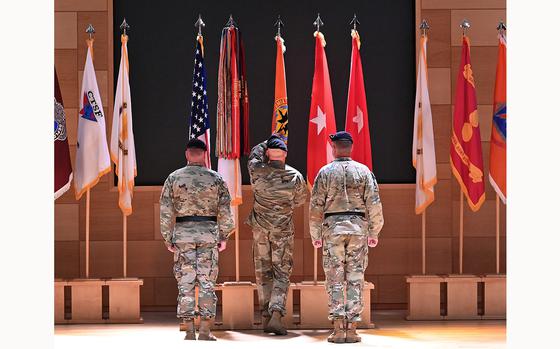 Left to right, Incoming Commander Brigadier General James D. Turinettim IV, Command Sergeant Major Michael R. Conaty, and Presiding Official, Lieutenant General Christopher O. Mohan during the Passing of the Colors, the APG flag, at the Assumption of Command ceremony. U.S. Army Brig. Gen. James Turinetti IV assumed command as the APG Senior Commander and CECOM Commanding General Friday morning. (Jeffrey F. Bill/Staff photo)
