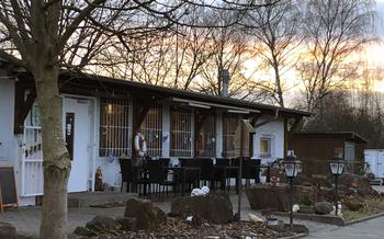 An outdoor seating area in front of a small white building