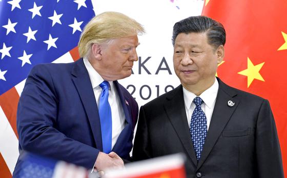 President Donald Trump shakes hands with China’s President Xi Jinping.