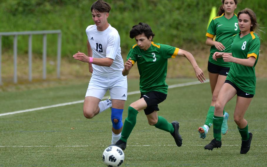 Alconbury’s MJ Hash gets to the ball ahead of Ansbach’s Nathan Arrequin in a Division III semifinal at the DODEA-Europe soccer finals in Landstuhl, Germany, May 22, 2024. Ansbach won the game 7-1 and will face AFNORTH in Thursday’s final. At right are Sofia Politis and Isabella Minjarez.