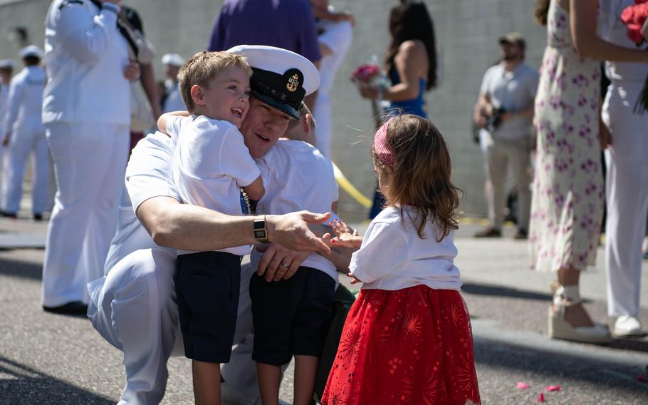 Navy Chief Operations Specialist Noah Wicks greets his children May 19, 2024, after returning home to Naval Station Mayport, Fla., after a deployment in the Middle East.