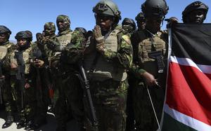 Kenyan police, who are part of a UN-backed multinational force, pray on the tarmac after landing at the Toussaint Louverture International Airport in Port-au-Prince, Haiti, Thursday, Feb. 6, 2025. (AP Photo/Odelyn Joseph)