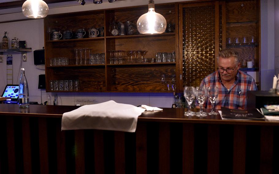 Martin Marker gets together drinks at the bar of Markers Kleines Restaurant in Weilerbach, Germany, on Aug. 11, 2023. The eatery offers an assortment of wines, including those from the Schroth vineyard in Asselheim.